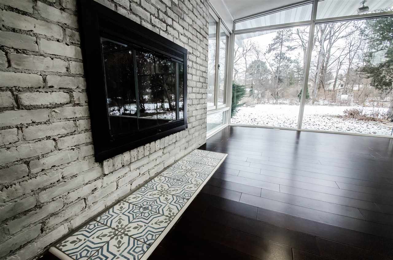 3209 North View Road Rockford, IL 61107 - Photo 6 of 25 a view of a hallway with wooden floor and a fireplace