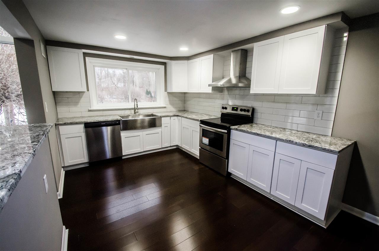3209 North View Road Rockford, IL 61107 - Photo 10 of 25 a kitchen with granite countertop a stove top oven sink and cabinets