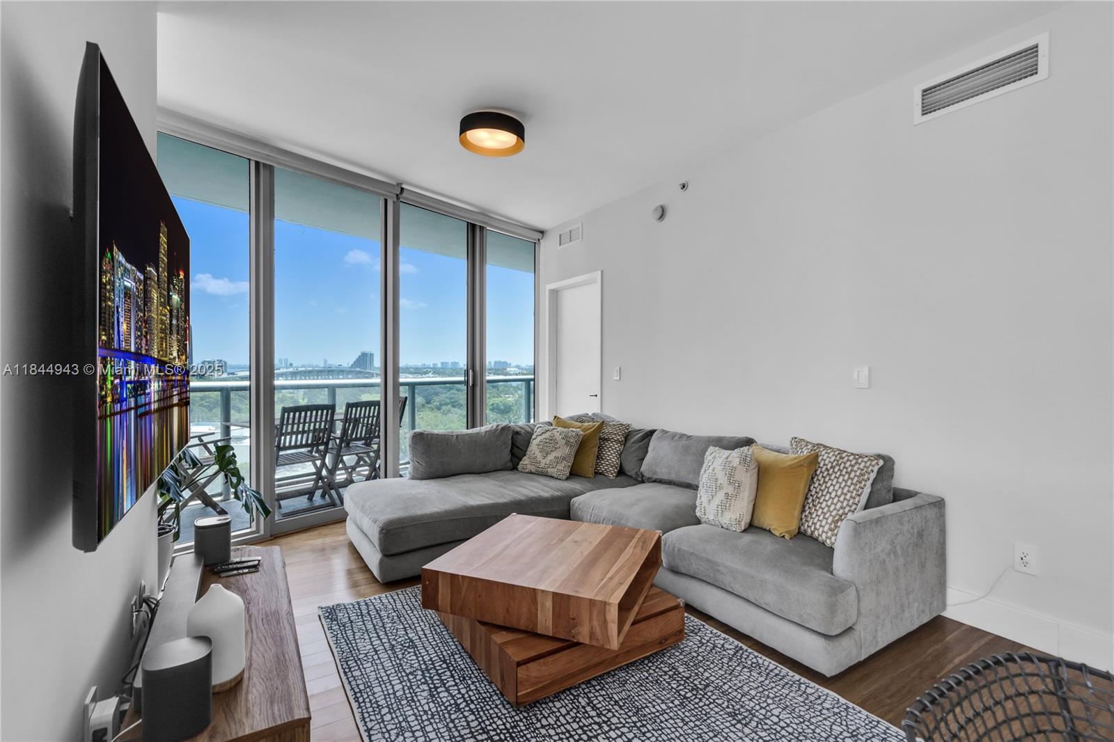 888 Biscayne Boulevard, Unit 812 Miami, FL 33132 - Photo 1 of 36 a living room with furniture and a flat screen tv