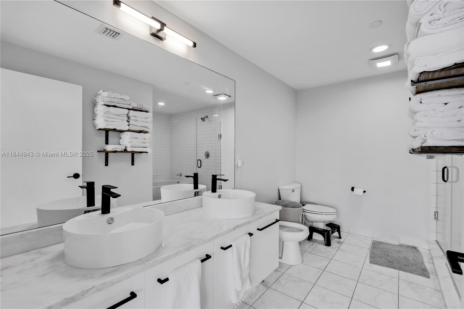888 Biscayne Boulevard, Unit 812 Miami, FL 33132 - Photo 14 of 36 a bathroom with a sink a toilet and a mirror