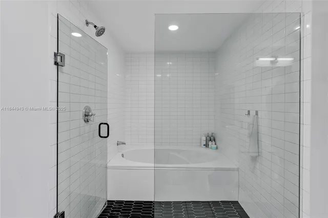 a bathroom with a bathtub and shower