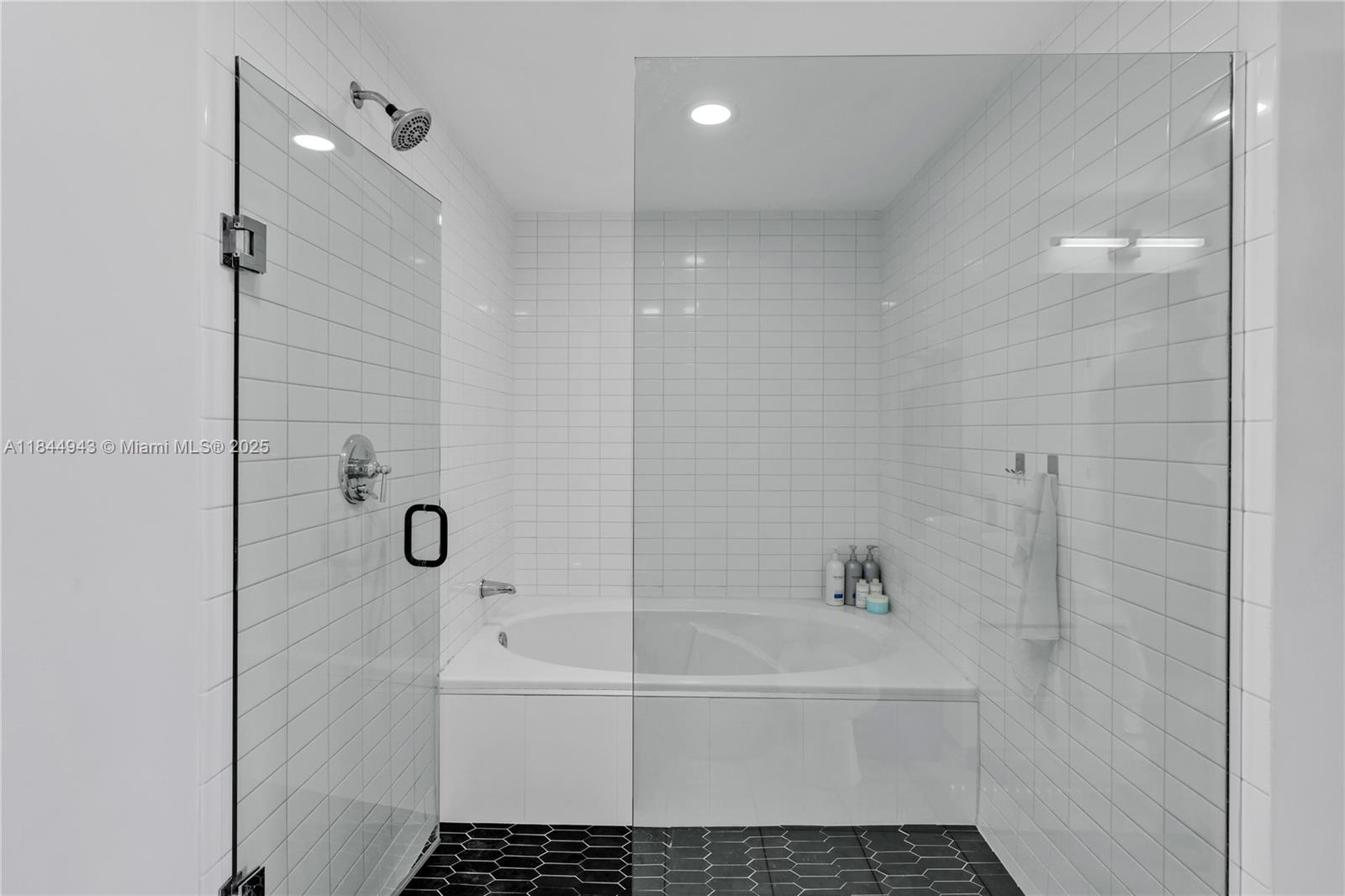 888 Biscayne Boulevard, Unit 812 Miami, FL 33132 - Photo 15 of 36 a bathroom with a bathtub and shower