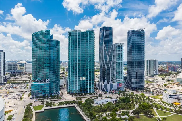 a front view of a multi story building with yard