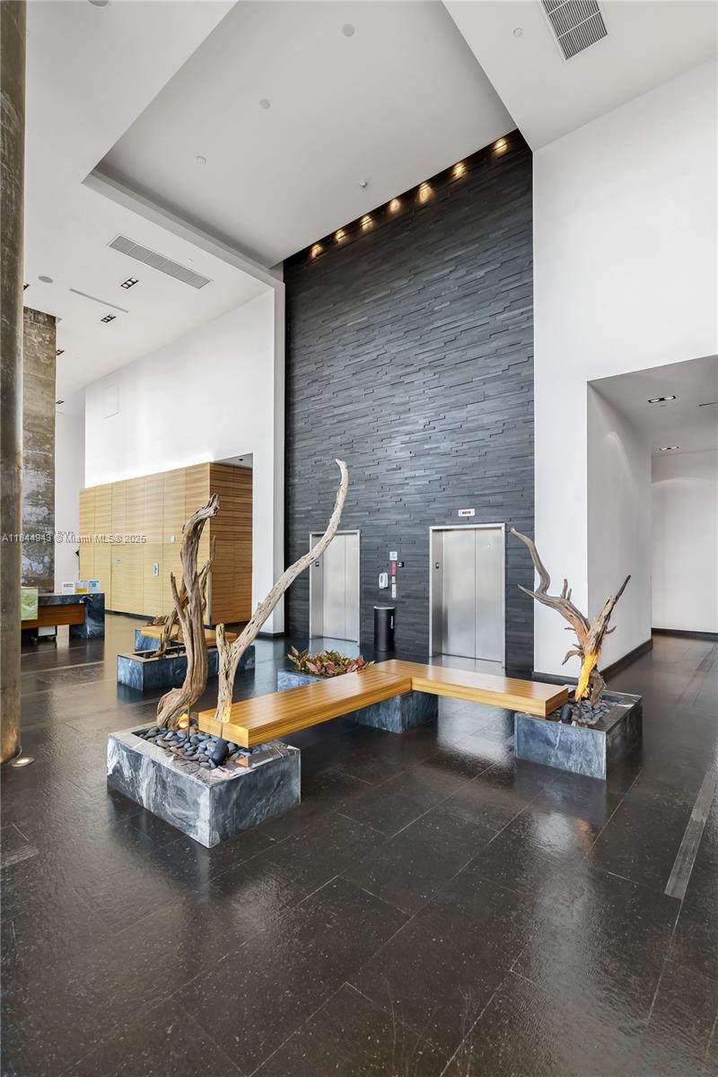 888 Biscayne Boulevard, Unit 812 Miami, FL 33132 - Photo 35 of 36 a view of a living room with floor to ceiling window