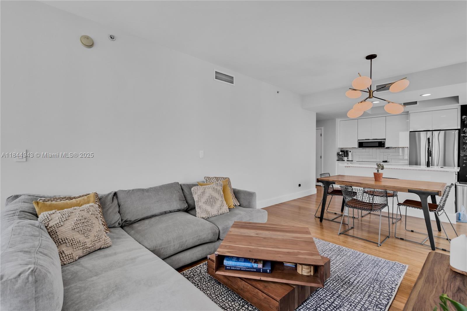 888 Biscayne Boulevard, Unit 812 Miami, FL 33132 - Photo 5 of 36 a living room with furniture and wooden floor