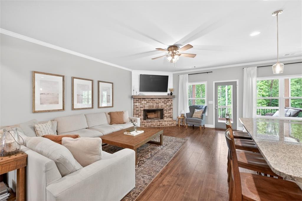 163 Hewett Road Pendergrass, GA 30567 - Photo 19 of 82 a living room with furniture fireplace and a large window