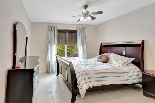 a bedroom with a large bed and a window