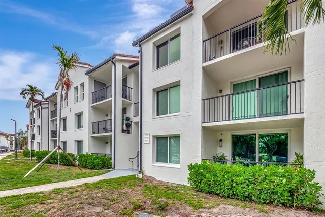 a view of a brick building next to a yard