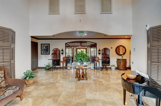 a living room with fireplace furniture and a potted plant