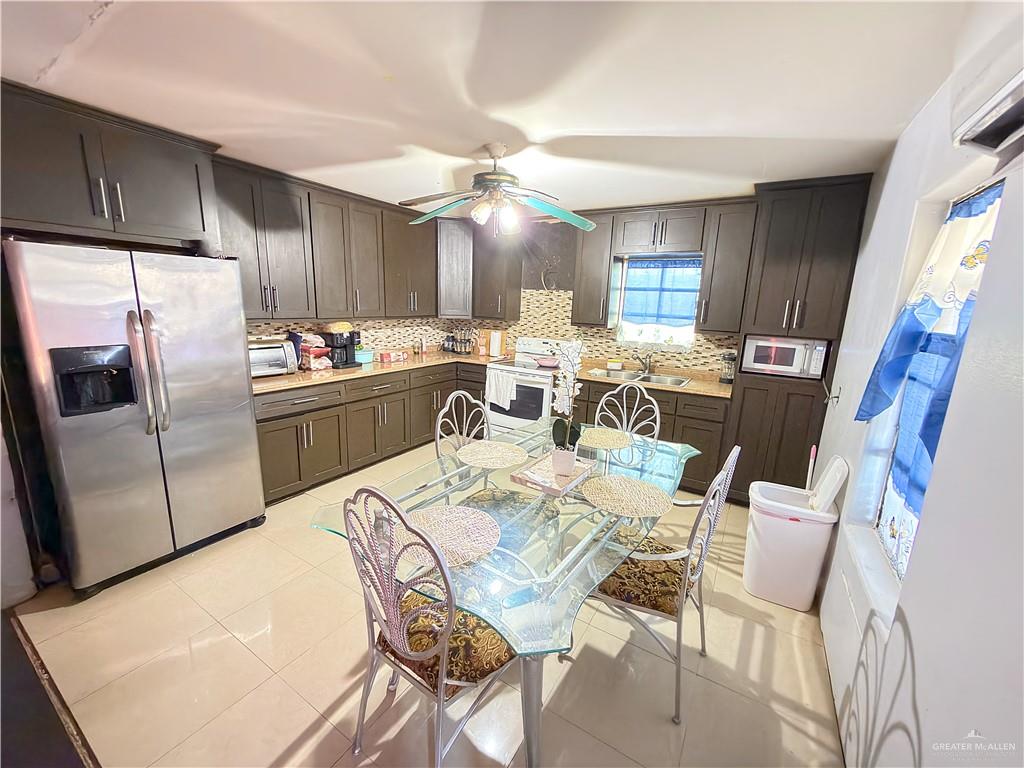 152 Paisano Street Sullivan City, TX 78595 - Photo 3 of 3 a view of a dining room with furniture a kitchen and chandelier