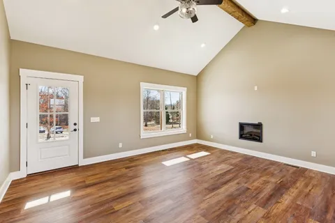 a kitchen with granite countertop white cabinets and stainless steel appliances