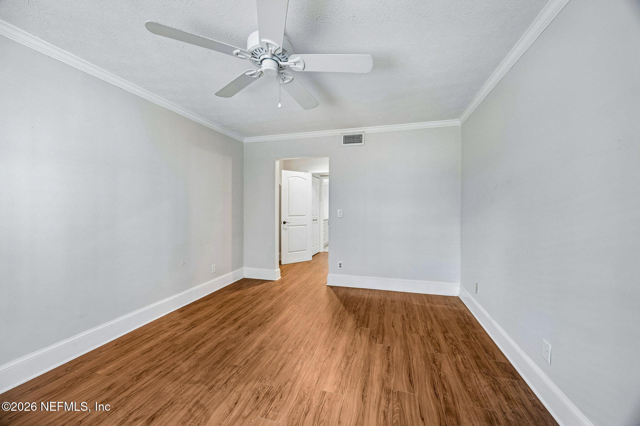 4358 Timuquana Road, Unit 134 Jacksonville, FL 32210 - Photo 10 of 31 wooden floor in an empty room with a window