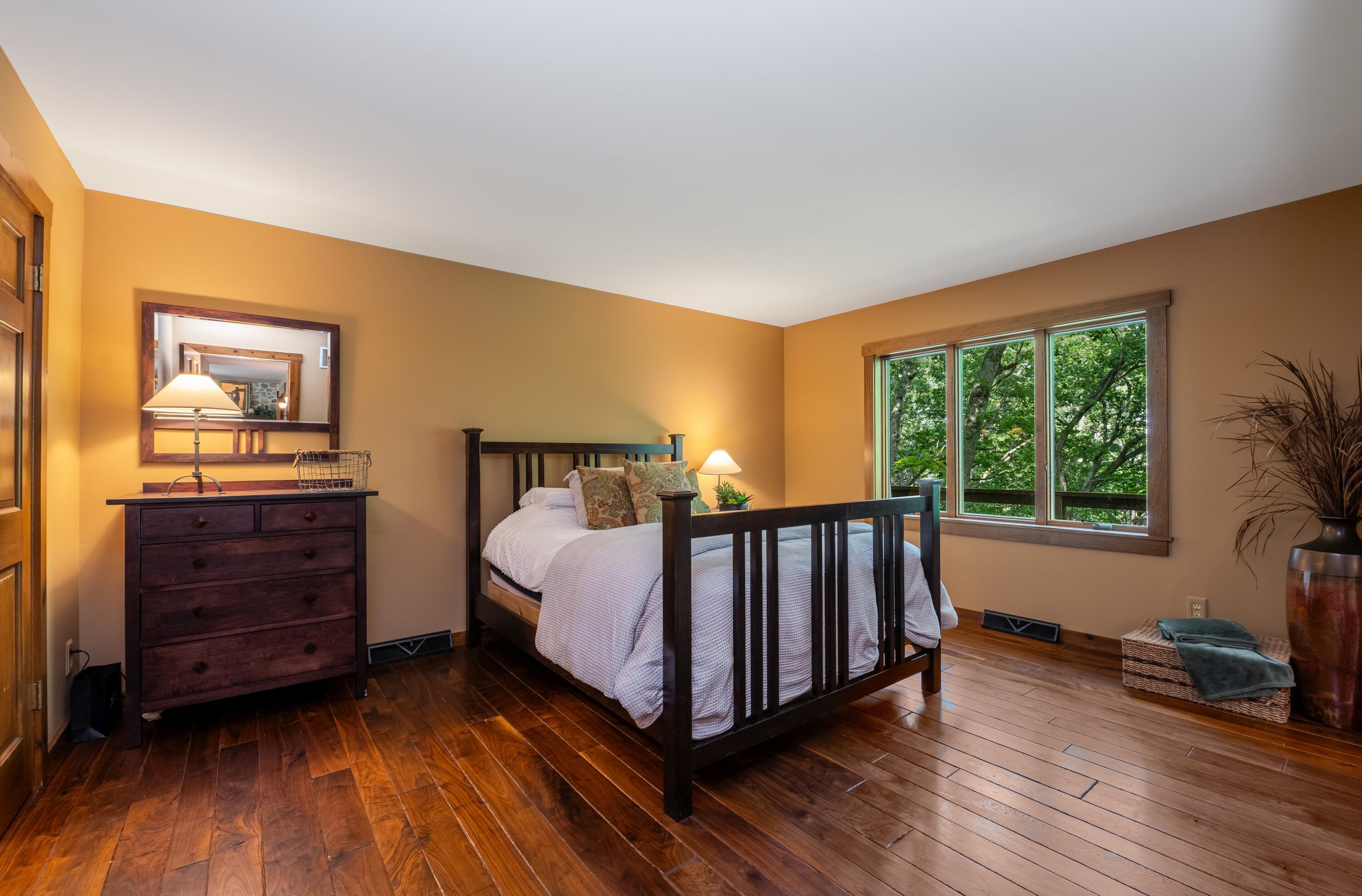 W3895 Timber Lake Road Troy, WI 53120 - Photo 19 of 64 Main Floor owner's suite with Black Walnut Floors and views of Pabst Lake