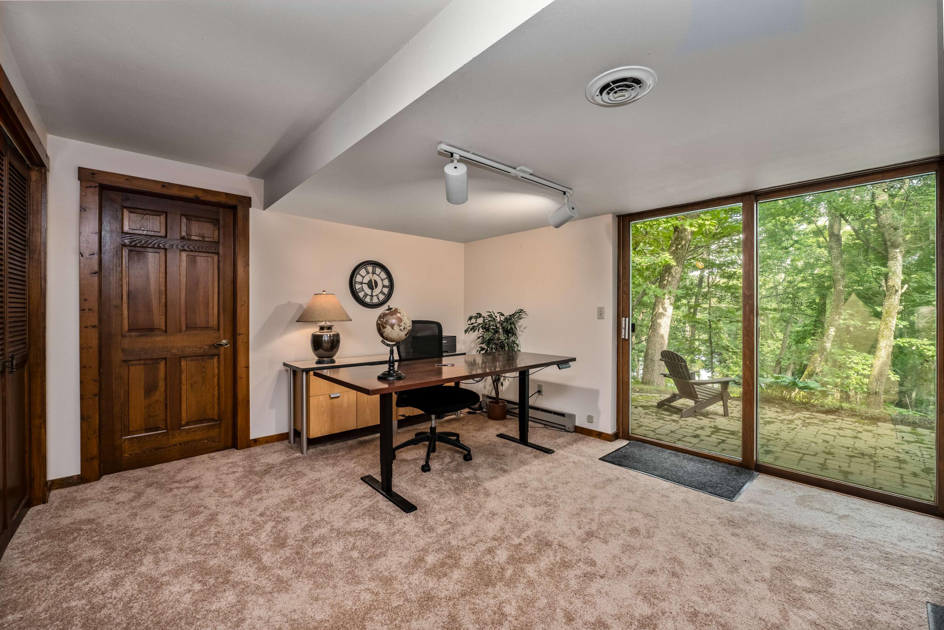 W3895 Timber Lake Road Troy, WI 53120 - Photo 27 of 64 Bedroom 4 on lower level with closet and large walk-in storage area. Walkout to patio and view of lake!