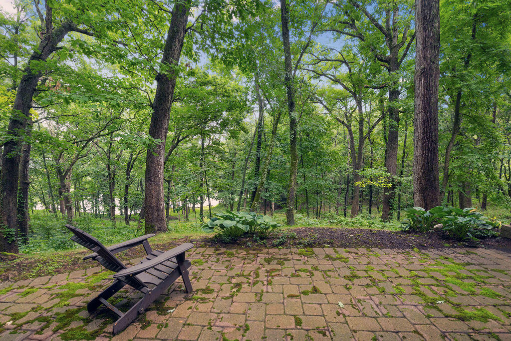 W3895 Timber Lake Road Troy, WI 53120 - Photo 30 of 64 Charming paver patio outside lower level that connects to pool and path to lake. Lake views!