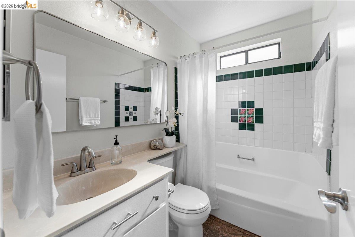 858 Coral Ridge Circle Rodeo, CA 94572 - Photo 28 of 52 Bathroom featuring a built-in vanity with an undermount sink, brushed nickel faucet, and a large frameless mirror