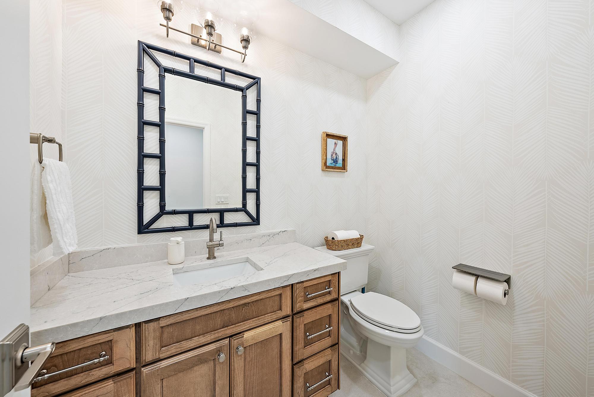 19 Island Road Sewall's Point, FL 34996 - Photo 31 of 50 a bathroom with a toilet a sink and mirror