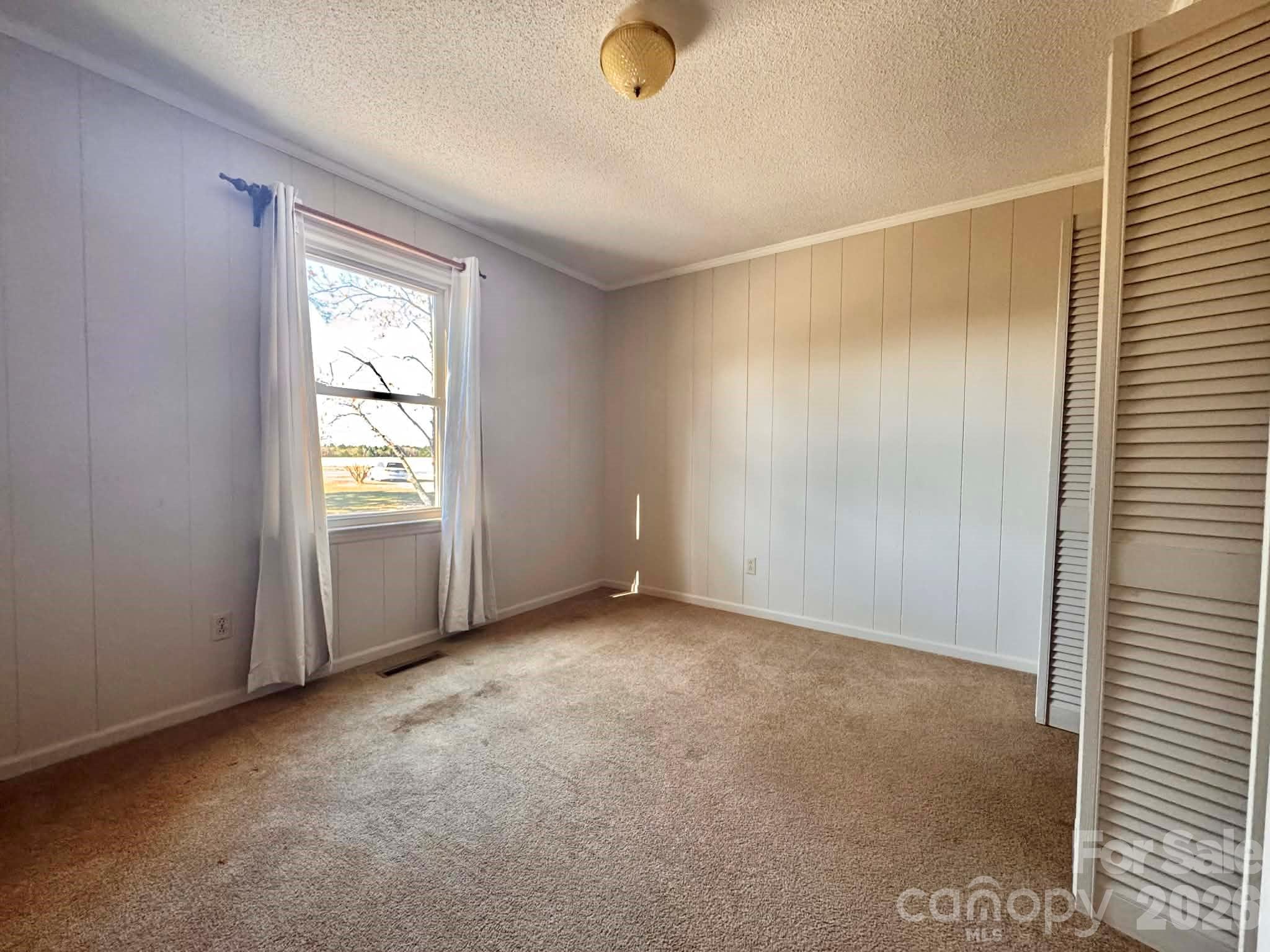 769 Dowd Road Candor, NC 27229 - Photo 12 of 32 a view of an empty room with a window