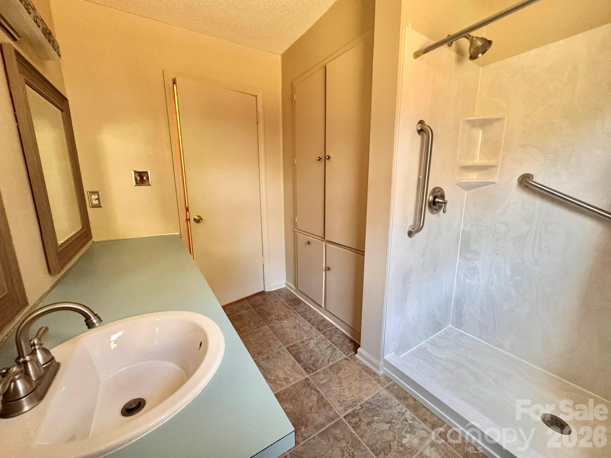 769 Dowd Road Candor, NC 27229 - Photo 14 of 32 a bathroom with a sink and shower