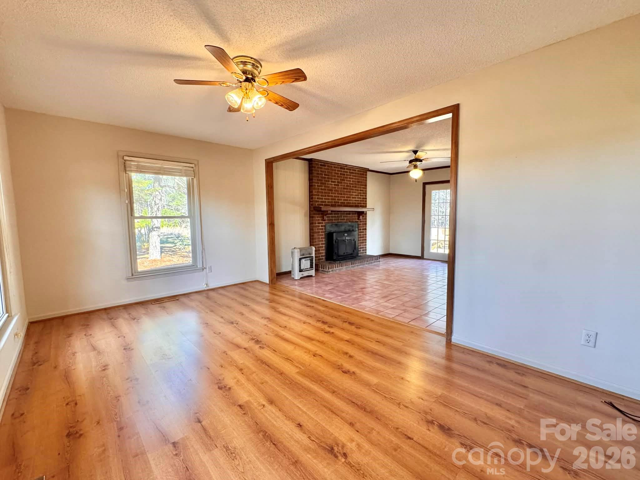 769 Dowd Road Candor, NC 27229 - Photo 3 of 32 a view of empty room with wooden floor and fan