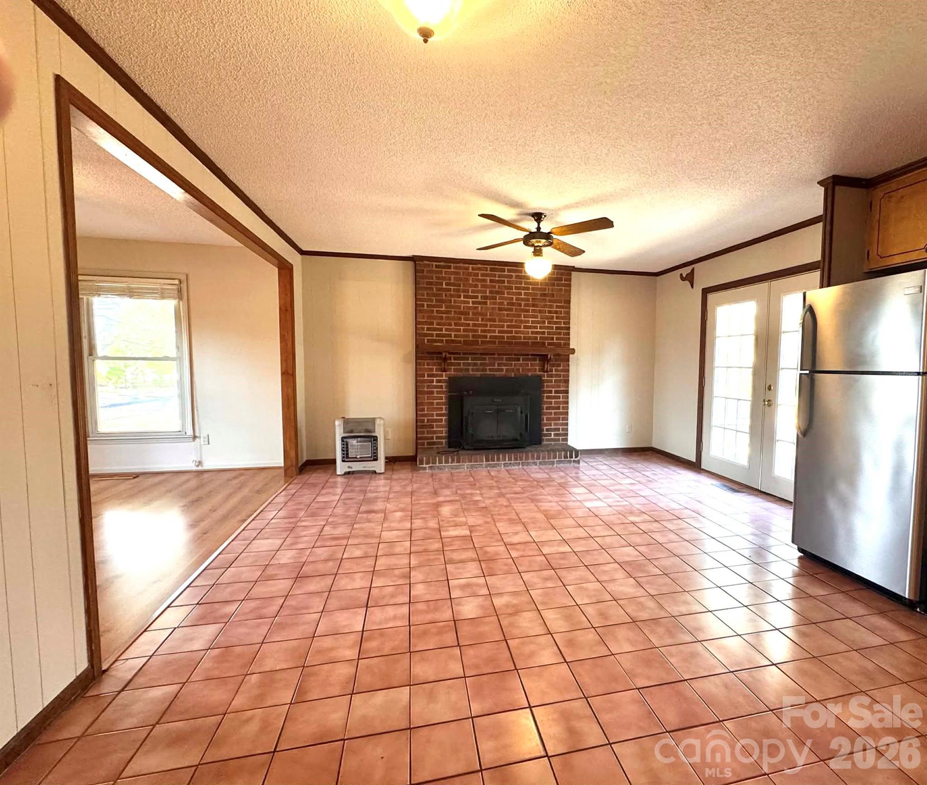 769 Dowd Road Candor, NC 27229 - Photo 6 of 32 a view of empty room with a fireplace and wooden floor
