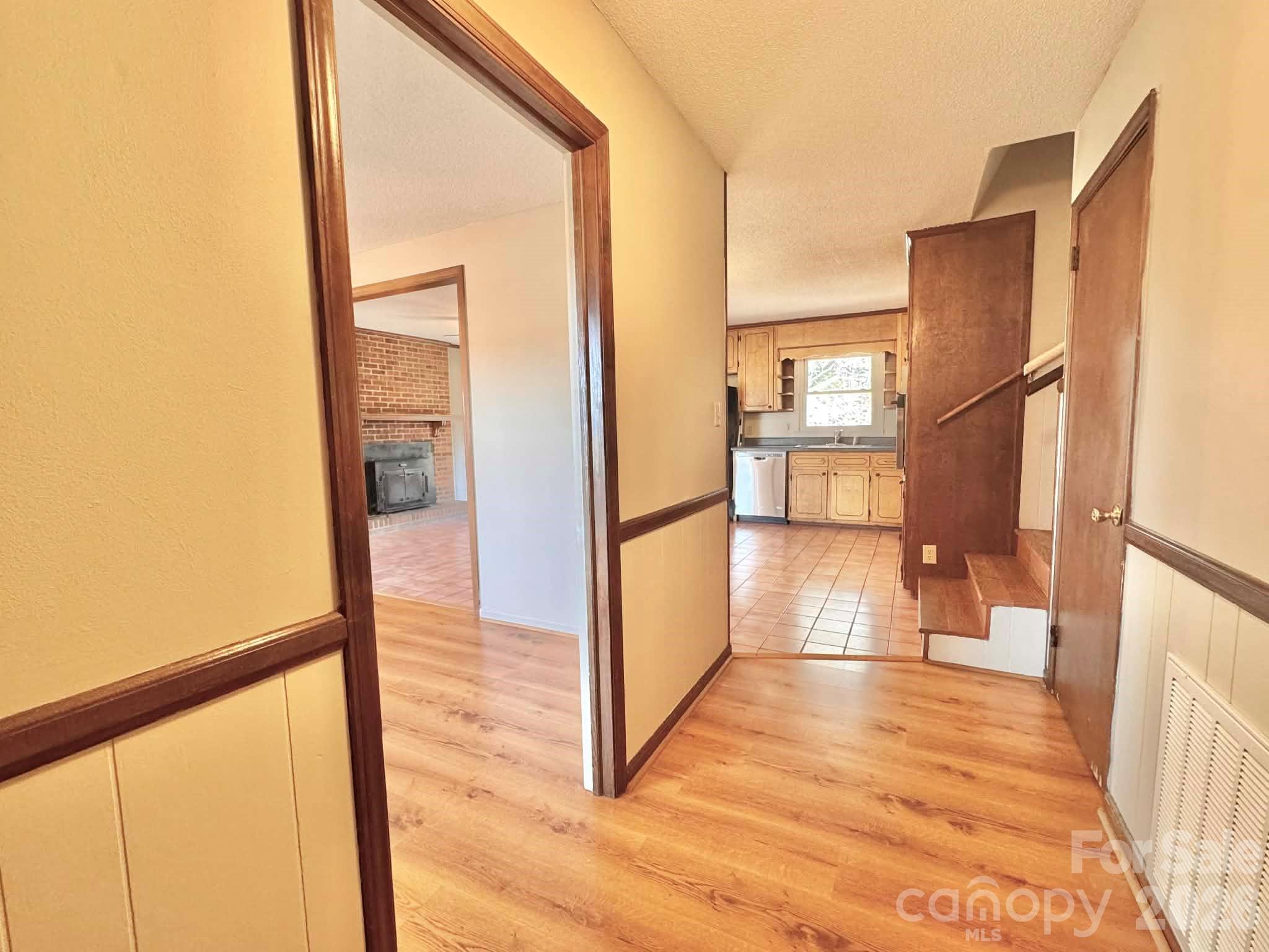 769 Dowd Road Candor, NC 27229 - Photo 8 of 32 a view of a hallway with wooden floor and a living room