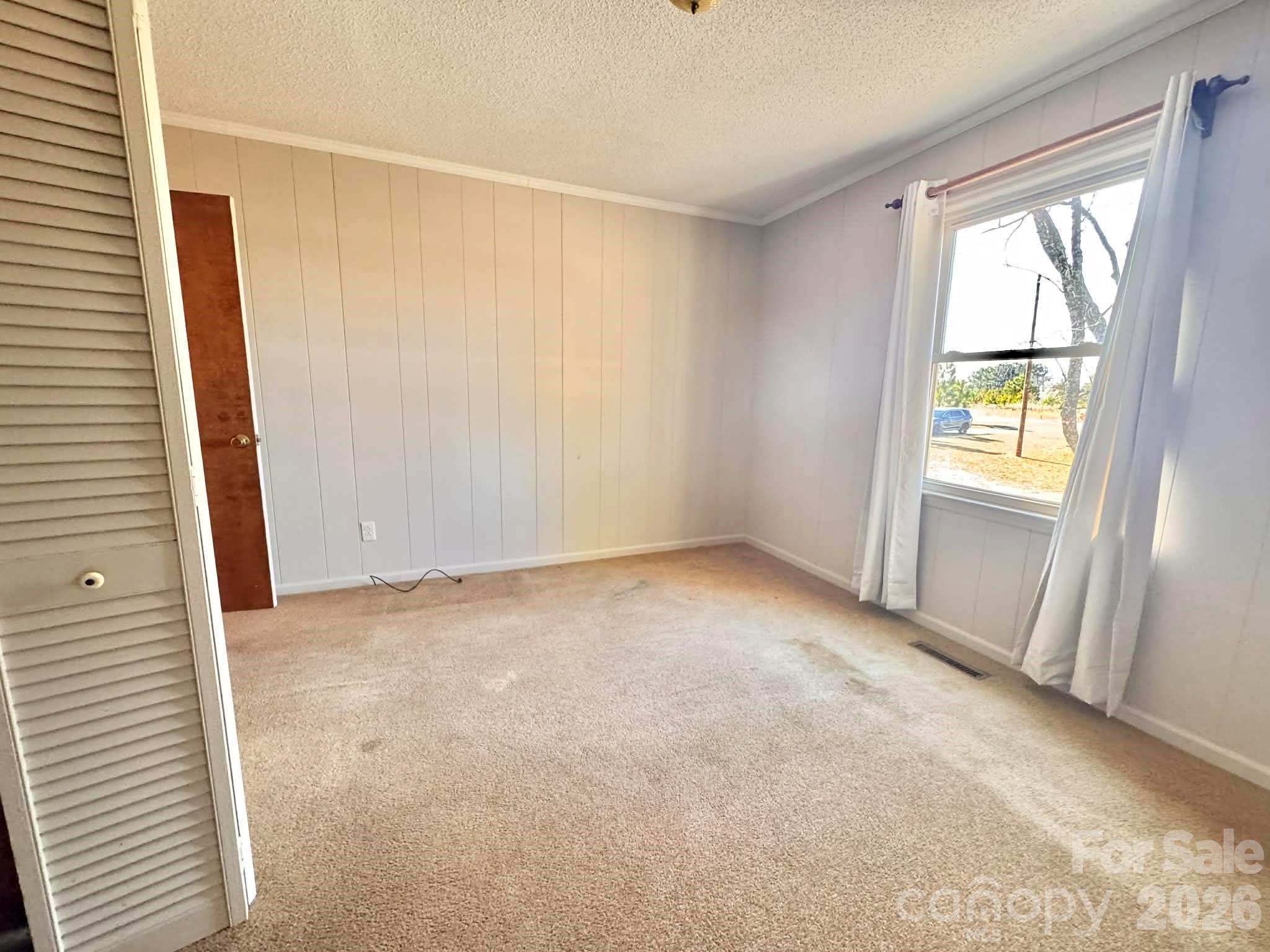 769 Dowd Road Candor, NC 27229 - Photo 10 of 32 an empty room with windows