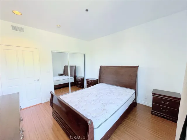 a bedroom with a bed and a tv on table
