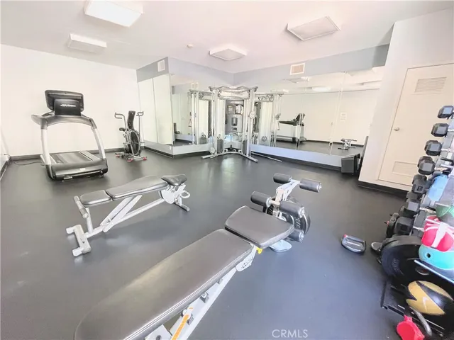 a room with gym equipment and a table