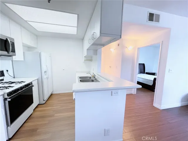 a kitchen with a stove and a refrigerator