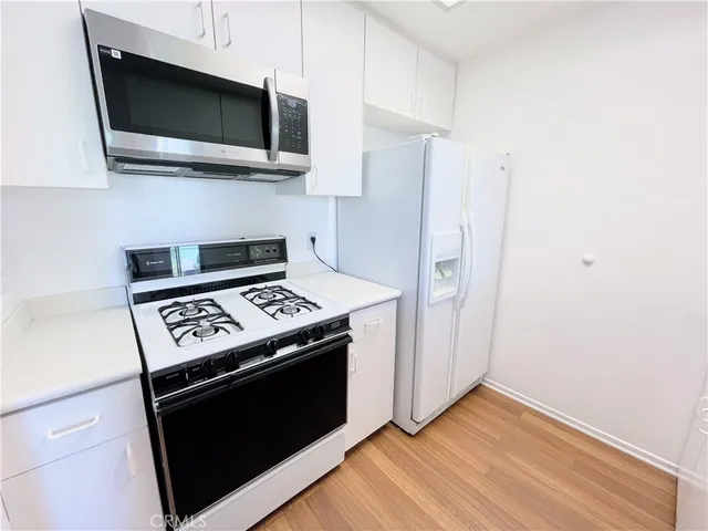a kitchen with stainless steel appliances a stove a microwave and cabinets