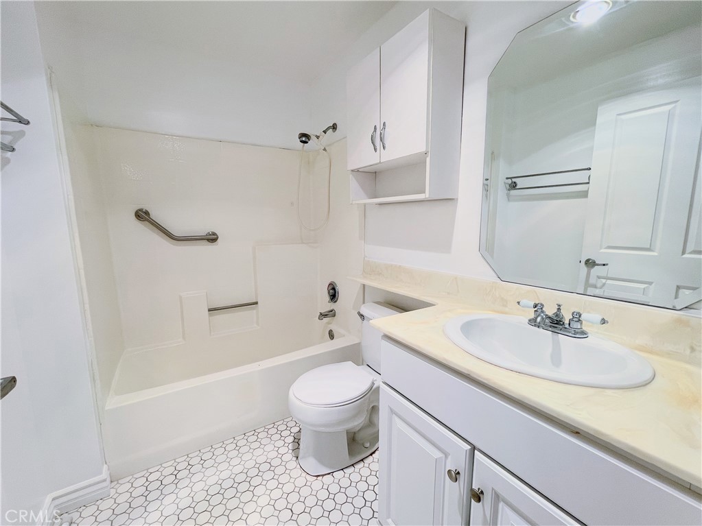 19350 Sherman Way, Unit 137 Reseda, CA 91335 - Photo 6 of 21 a bathroom with a sink toilet vanity and shower