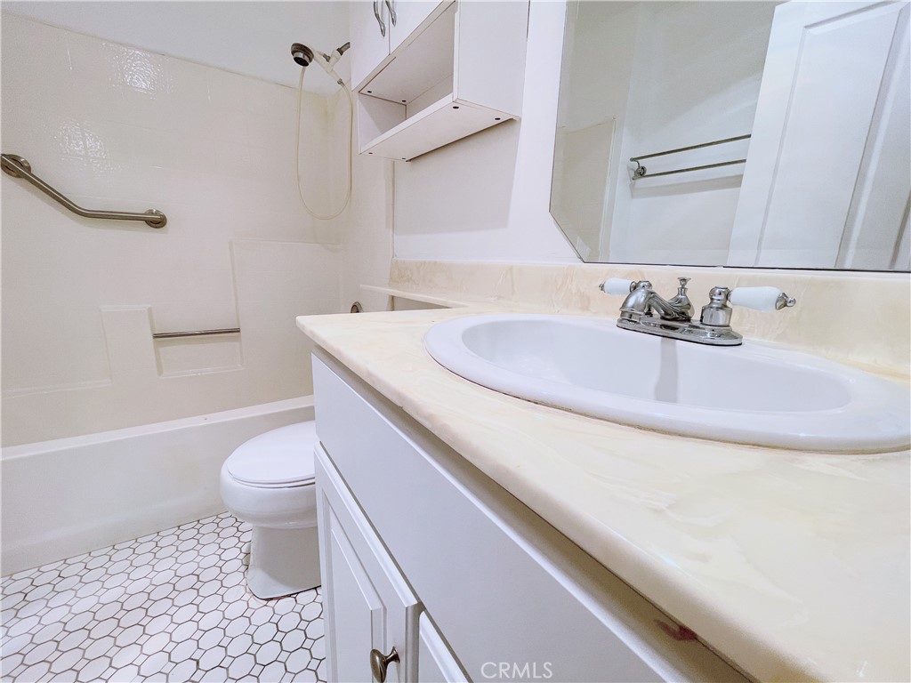 19350 Sherman Way, Unit 137 Reseda, CA 91335 - Photo 7 of 21 a bathroom with a sink a toilet and a bathtub