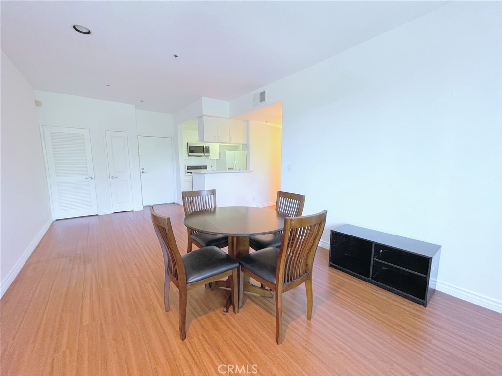 19350 Sherman Way, Unit 137 Reseda, CA 91335 - Photo 9 of 21 a view of a dining room with furniture and wooden floor