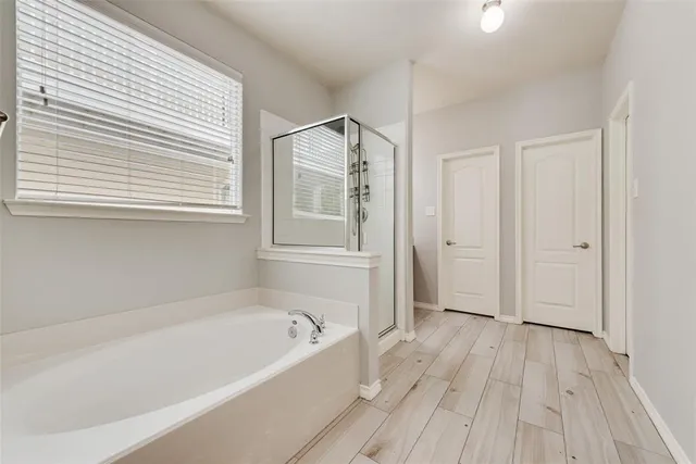 a bathroom with a bathtub and a window