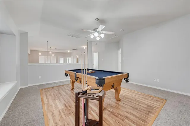 a view of a dining room with furniture and a chandelier