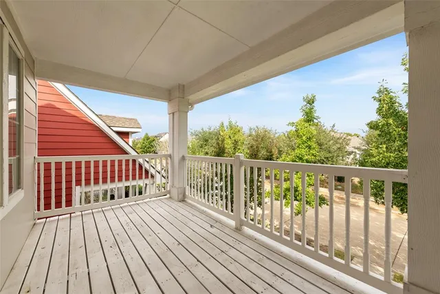 a view of balcony with wooden floor