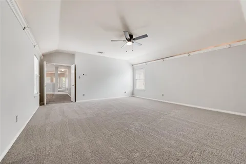 a view of an empty room with a ceiling fan