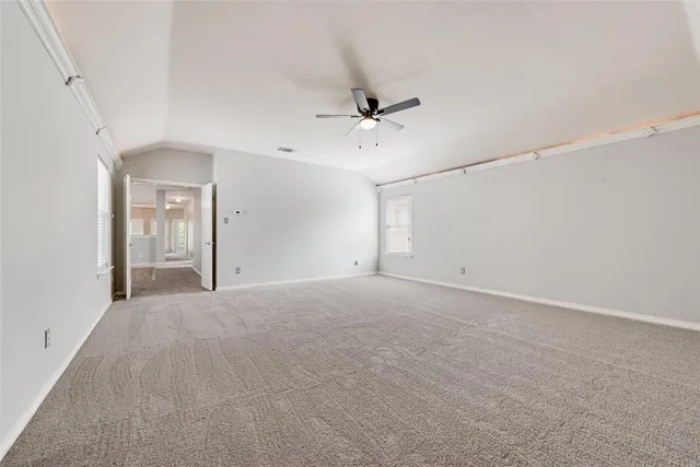 a view of an empty room with a ceiling fan