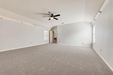 a view of a livingroom with a ceiling fan and window
