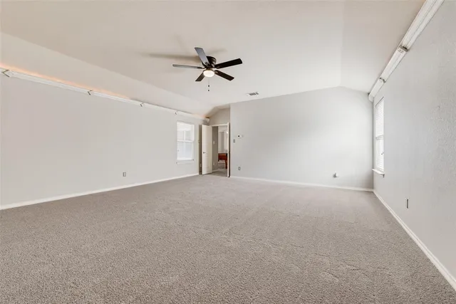 a view of a livingroom with a ceiling fan and window