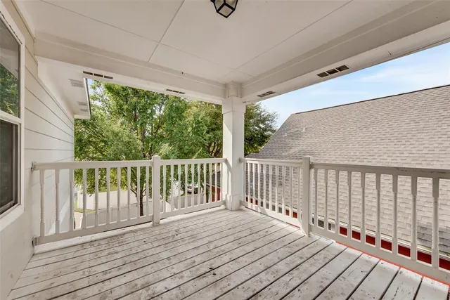 a view of balcony with wooden floor