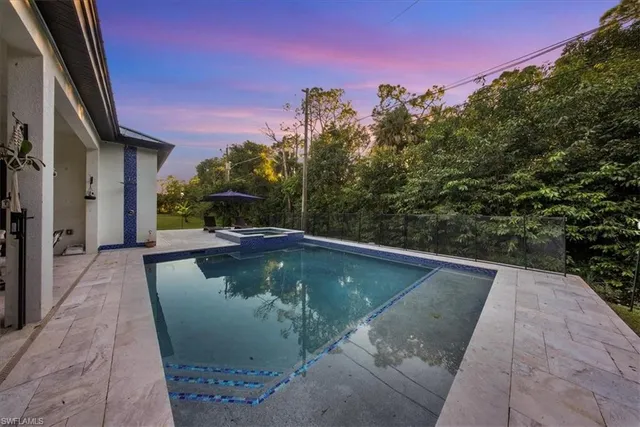 a view of a swimming pool with a yard