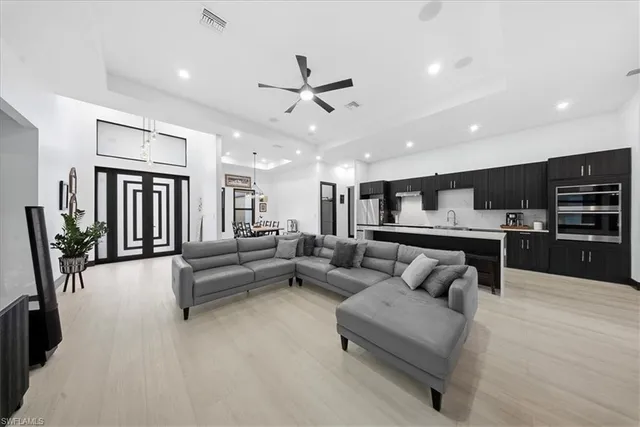 a large white kitchen with a large window