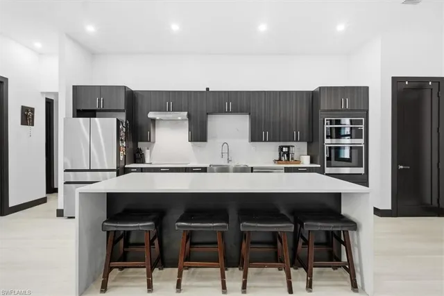 a living room with furniture and kitchen view