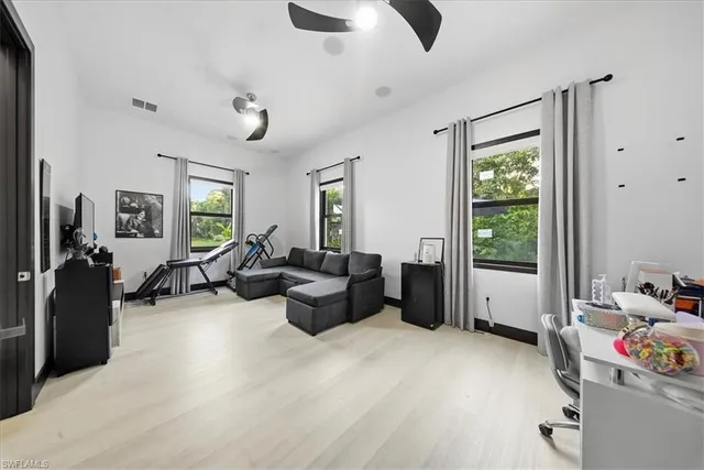 a kitchen with cabinets a sink stainless steel appliances and chairs