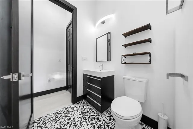 a bathroom with a toilet sink and shower