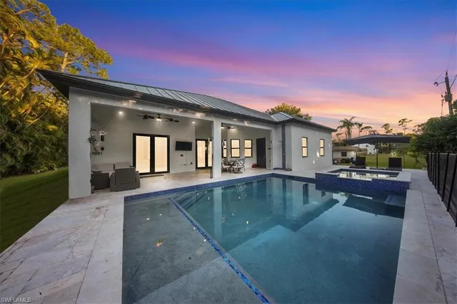 a view of a house with swimming pool and sitting area