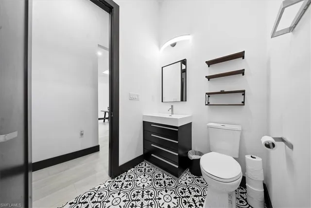 a bathroom with a sink toilet a mirror and shower