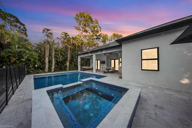a view of house with swimming pool in front of it